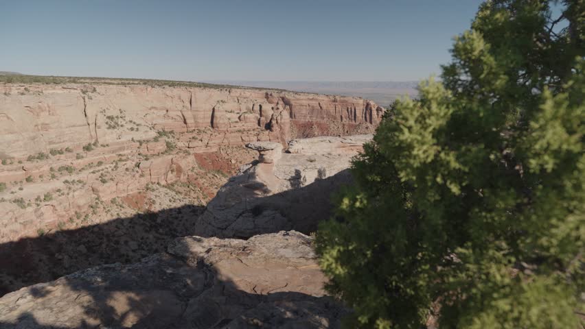 Colorado National Monument Park near the city of Grand Junction. Sheer-walled, Red rock canyons, Rim Rock Drive, Towering monoliths within a vast plateau and canyon panorama USA