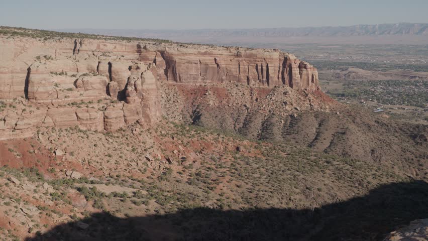 Colorado National Monument Park near the city of Grand Junction. Sheer-walled, Red rock canyons, Rim Rock Drive, Towering monoliths within a vast plateau and canyon panorama USA