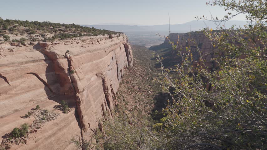 Colorado National Monument Park near the city of Grand Junction. Sheer-walled, Red rock canyons, Rim Rock Drive, Towering monoliths within a vast plateau and canyon panorama USA