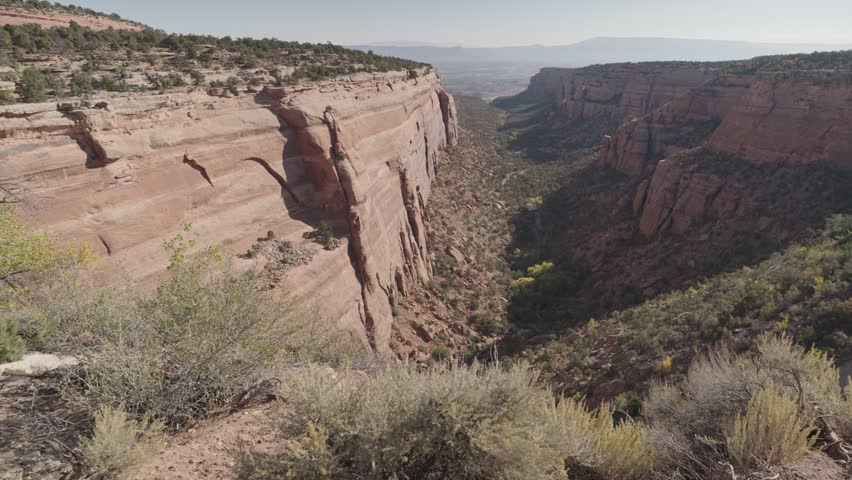 Colorado National Monument Park near the city of Grand Junction. Sheer-walled, Red rock canyons, Rim Rock Drive, Towering monoliths within a vast plateau and canyon panorama USA