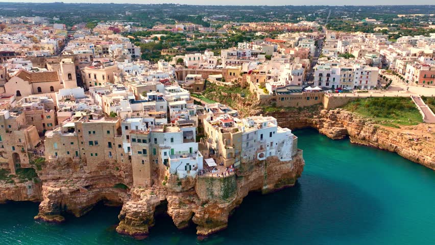 scenic seaside town in southern Italy, Polignano a Mare in Puglia, Italy, aerial view of Italian village of Polignano on the coast of Adriatic Sea, historic traditional touristic town in Italy. 