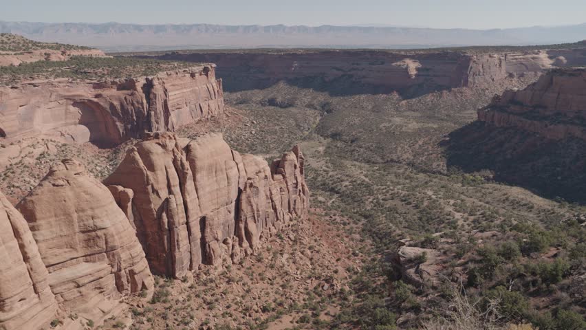 Colorado National Monument Park near the city of Grand Junction. Sheer-walled, Red rock canyons, Rim Rock Drive, Towering monoliths within a vast plateau and canyon panorama USA