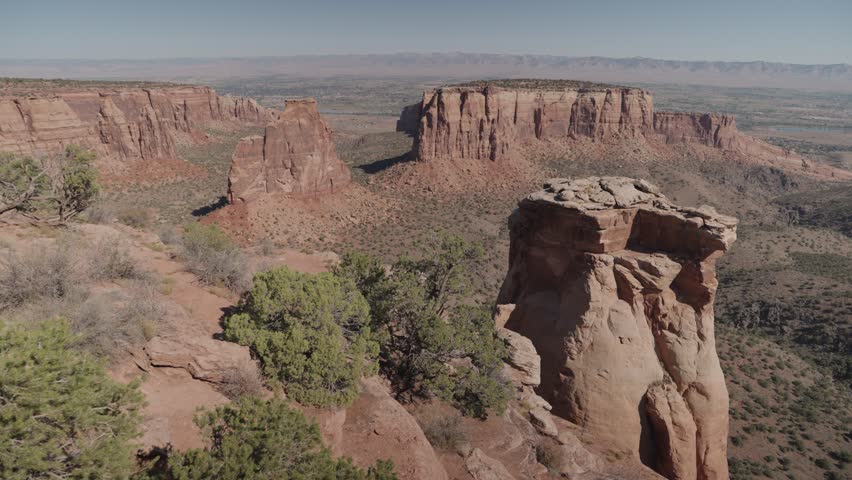 Colorado National Monument Park near the city of Grand Junction. Sheer-walled, Red rock canyons, Rim Rock Drive, Towering monoliths within a vast plateau and canyon panorama USA