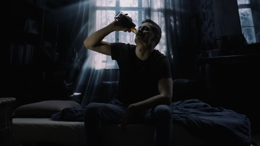 Man In Dark Room Sitting On Bed Drinking Alone Moody Cinematic Depression Loneliness