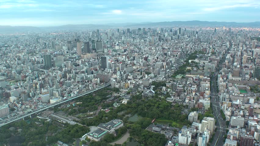 OSAKA, JAPAN : Aerial high angle sunset view of CITYSCAPE of OSAKA. View of buildings and street around Namba, Shinsaibashi, Umeda and Osaka station (downtown area). Time lapse shot, dusk to night.