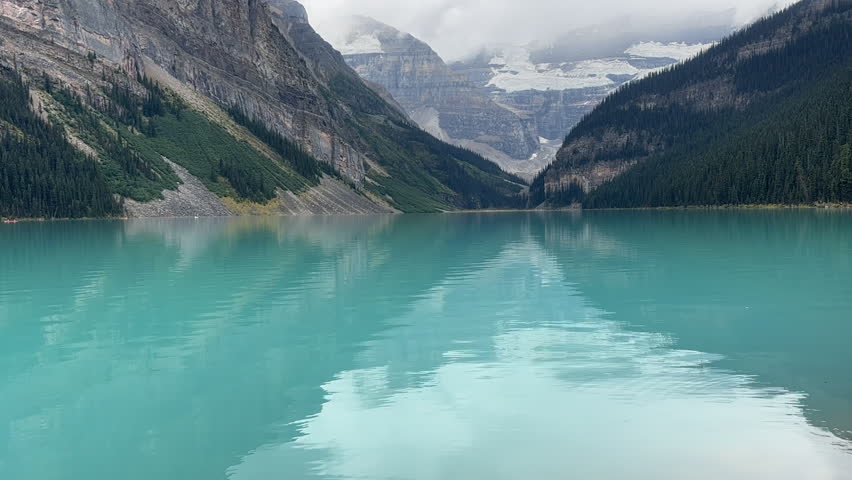 Mirrored Reflections Of Mountains On Turquoise Waters Of Lake Louise. Banff National Park, Alberta, Canada. timelapse