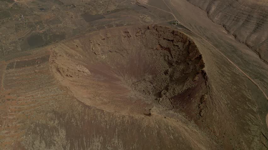 Volcano crater. Aerial view in orbit of volcano. Interior of a volcanic crater and lava outlet area. Canary Islands. Spain.