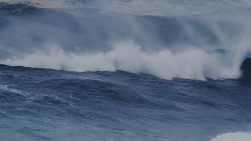 Powerful waves crashing over rocks in Sydney, Australia, with strong ocean currents and mist.