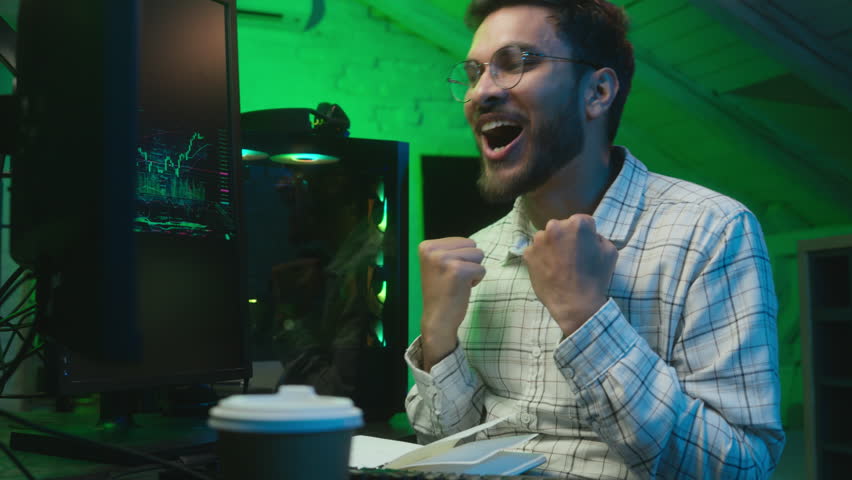 Caucasian man programmer gamer making wish crosses fingers for good luck ask for victory male guy software specialist looking at computer screen overjoyed winning rejoicing celebrating success win