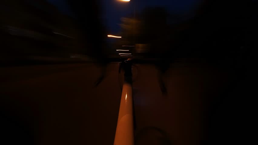 Cycling at night is a rapid time lapse through the streets of the city in first person view. The theme is urban transportation on sports bikes in downtown. Long exposure times form light trails.
