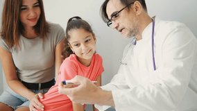 During a Pediatric Consultation, a Doctor is Friendly and Comforting while Discussing the Importance of Vaccination with a Young Patient - Powered by Shutterstock - Get 15% off with code: PIKWIZARD15
