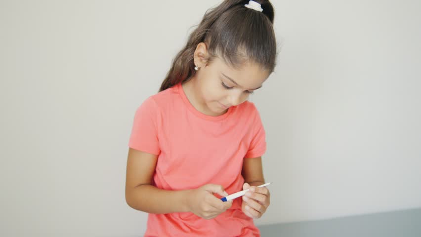 A young girl is preparing for her vaccination while wearing a bright tshirt, symbolizing health awareness and community engagement