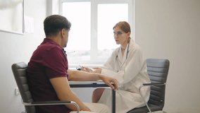 Elderly Man Consults with a Young Red-Haired Female Doctor During His Medical Appointment, Discussing His Health Concerns - Powered by Shutterstock - Get 15% off with code: PIKWIZARD15