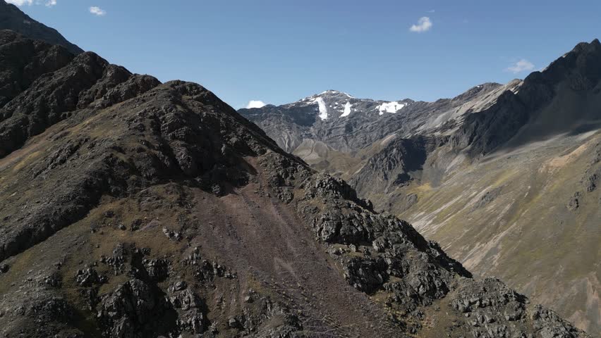 Aerial reveal of spectacular rocky summits, Peruvian Andes mountain tops