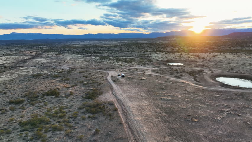 RV Parked In Desert Landscape Of Sedona In Arizona At Sunset - Drone Shot