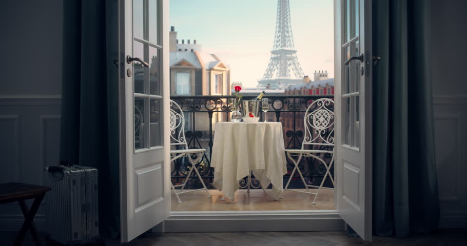 An Elegant Parisian Balcony with a Table Adorned With Champagne, Bowl with Strawberries, Rose Flower, Offering a Breathtaking View of the Eiffel Tower, Perfect for a Romantic and Luxurious Escape