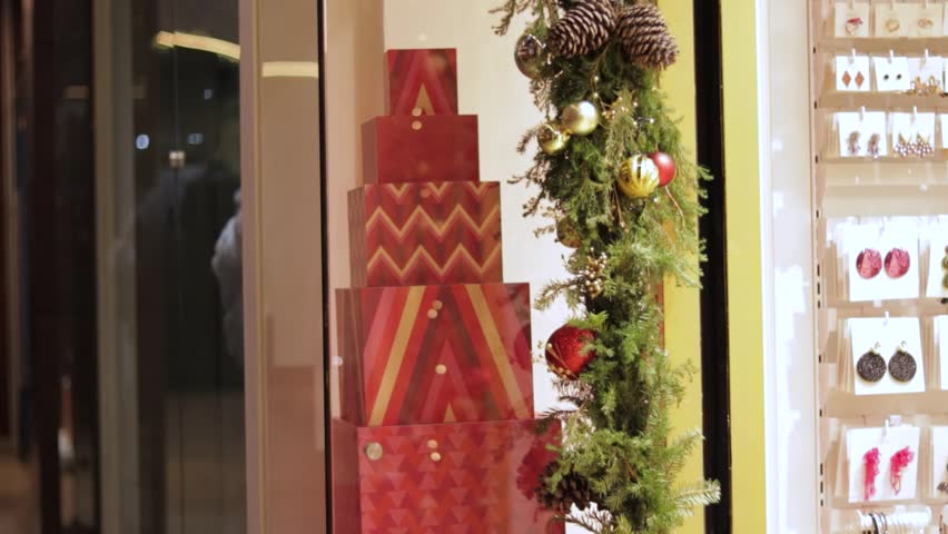 Christmas display with gift boxes and garland in a shop window, establisher