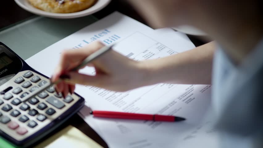 Family Tax Bill Debt Overspend. High Tax. Paying bills through on-line application using laptop,sorting out domestic, household papers. Planning family expenses manage budget, doing paperwork at home