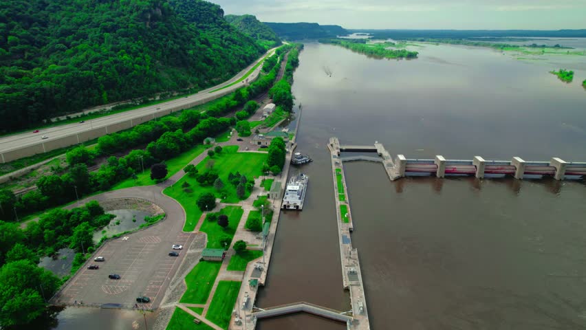 Tugboat approaching barge boat that is passing through the lock and dam system near La Crescent, Minnesota, on the Mississippi River. USA