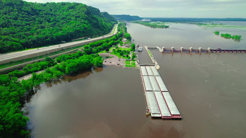 Aerial view of a barge boat passing through the lock and dam system near La Crescent, Minnesota, on the Mississippi River