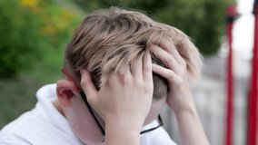 The boy feels a sharp headache while walking outside. School fatigue led to a migraine. - Powered by Shutterstock - Get 15% off with code: PIKWIZARD15