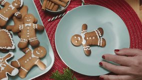 Making Christmas cookies - gingerbread men,  a woman is decorating cookies with royal icing. - Powered by Shutterstock - Get 15% off with code: PIKWIZARD15