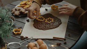 Preparing Christmas gingerbread cookies. Hands cutting out shapes for Christmas cookies from rolled ginger dough. - Powered by Shutterstock - Get 15% off with code: PIKWIZARD15