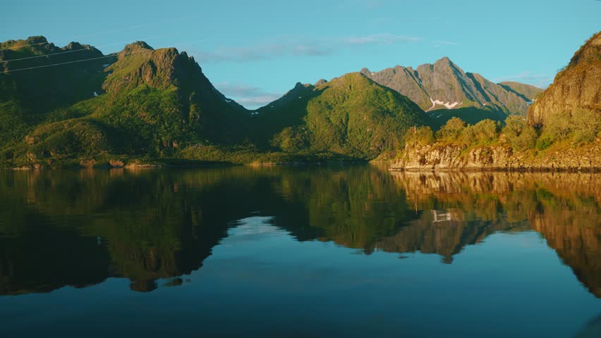 Scenic fjord with water reflection by sunset, Lofoten islands, Norway, Scandinavia.