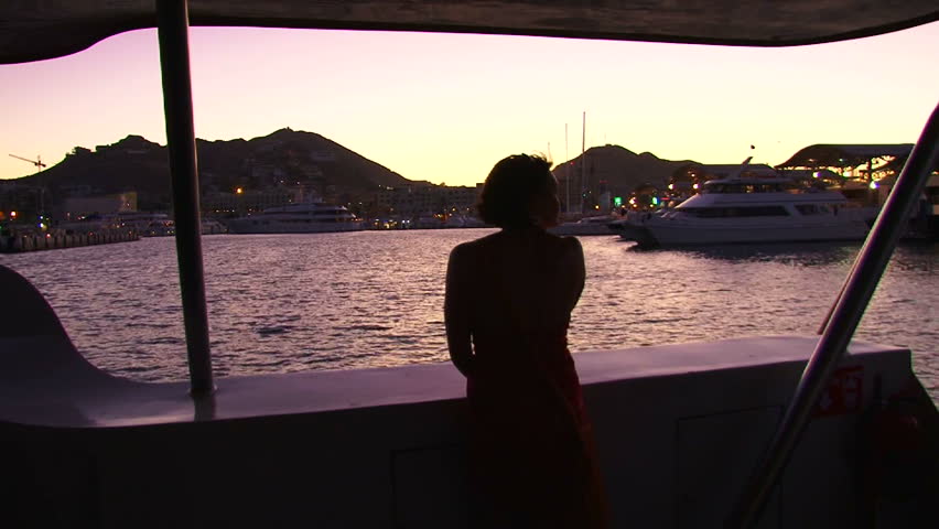 Model released woman enjoys the night scenery in Cabo San Lucas, Mexico on