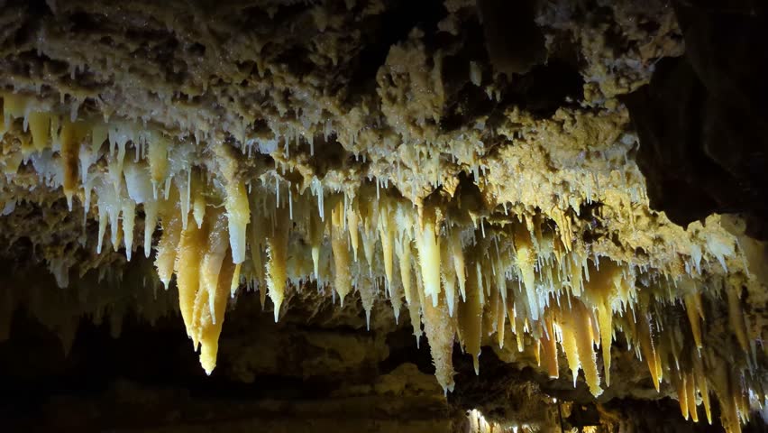 Icicle Shaped Stalactites on Cave Ceiling Produced by Precipitation of Minerals from Water Dripping Over Hundreds of Years 4K