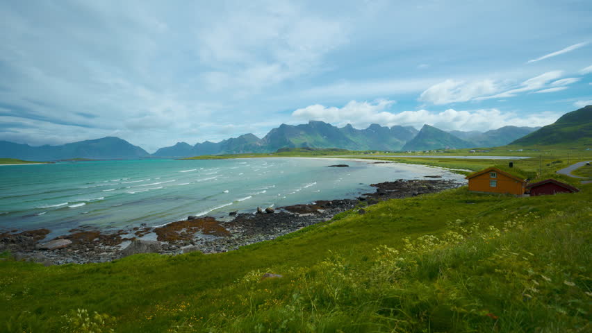 Scenic Lofoten island sandy beach cinemagraph, Norway, Scandinavia. Historic wooden houses. Seaside ocean bay