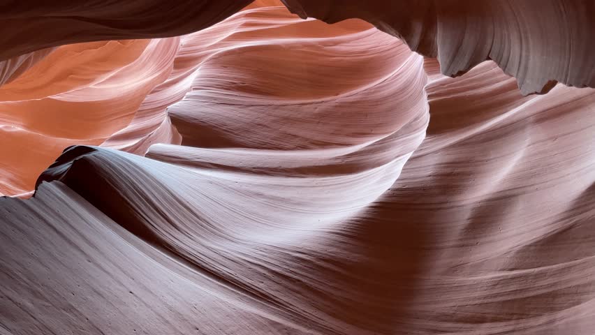 Experience the breathtaking beauty of Antelope Canyon, where sunlight illuminates swirling sandstone formations, creating mesmerizing patterns and vibrant colors, especially enchanting at midday.