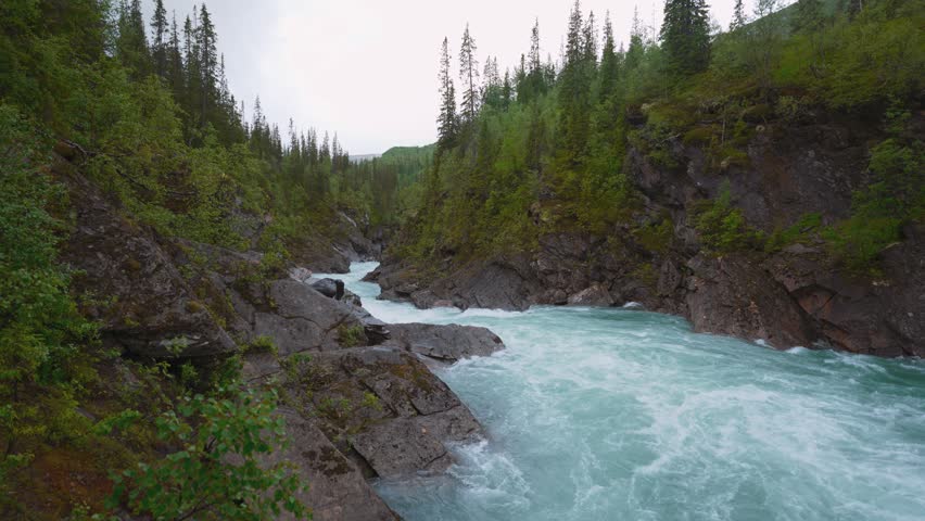Marmorfossen mountain river, Northern Norway. Flowing water through marble stone. Scenic nature