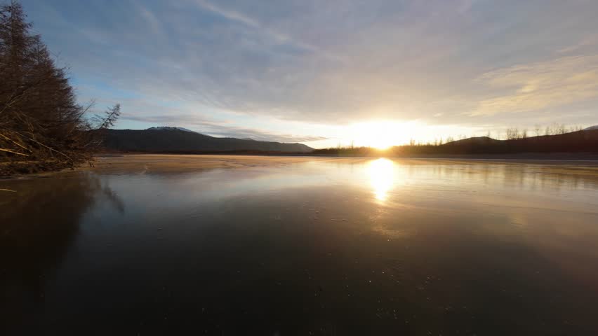 Experience the breathtaking beauty of Yakutia as dawn breaks over its icy terrains. This aerial exploration reveals nature