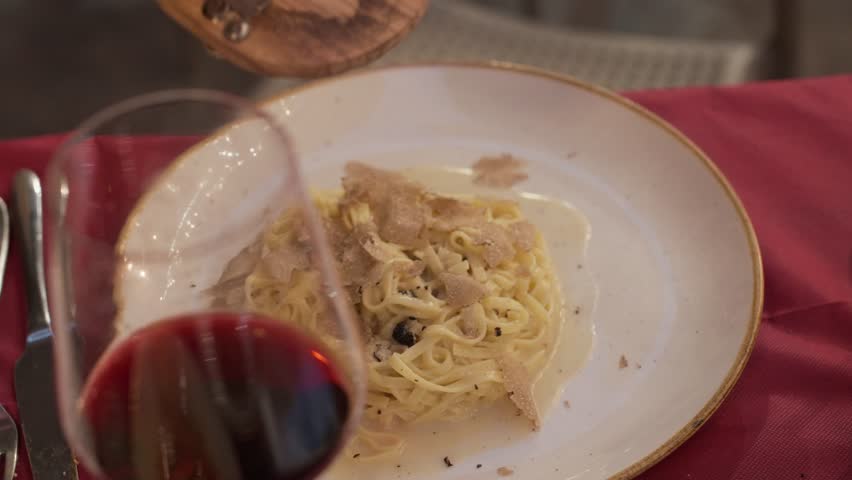 Fresh truffles are shaved onto a plate of pasta in Siena, Italy.