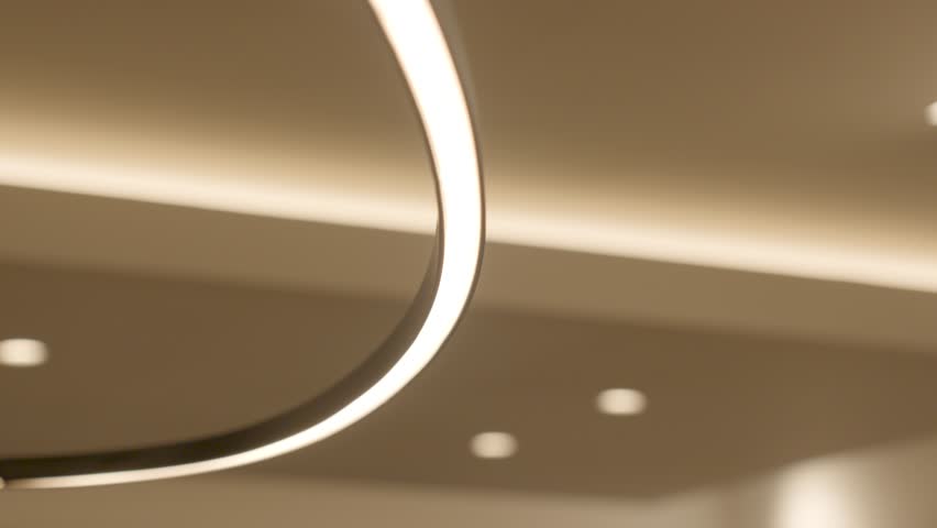 slow orbiting shot of bright circular led lights lighting a villa