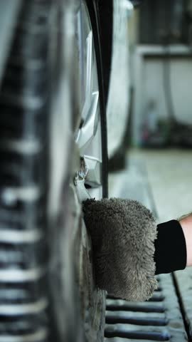 Washing Car Wheel with Foam Mitt