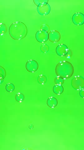Super slow motion of flying soap bubbles on green screen background , vertical orientation ,1000 FPS