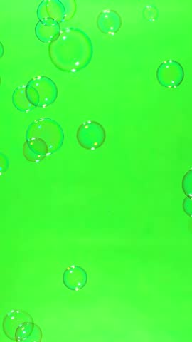 Super slow motion of flying soap bubbles on green screen background , vertical orientation ,1000 FPS