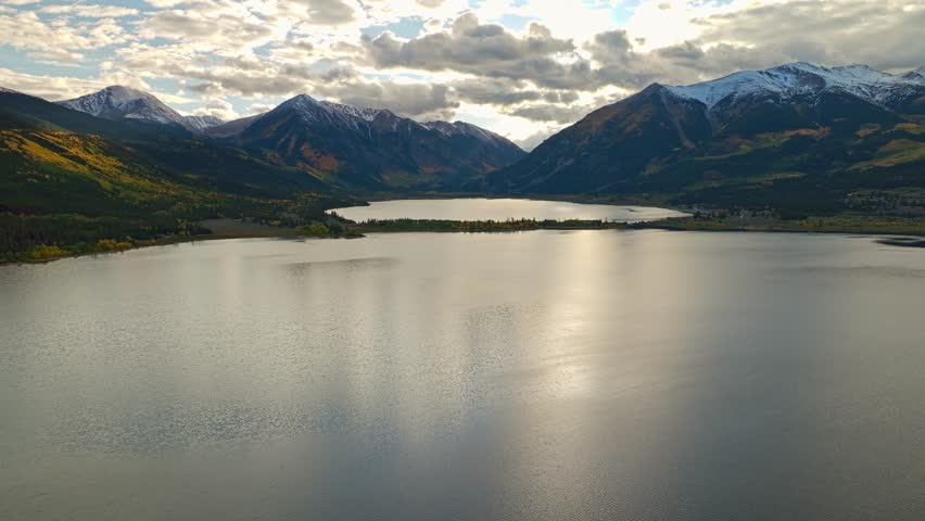 Aerial view of a calm lake with mountain peaks reflecting in the water at Independence Pass, Colorado