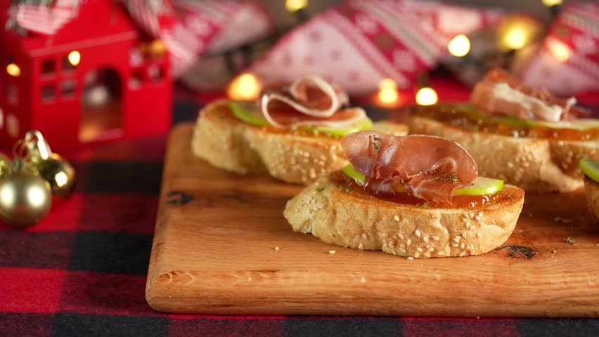 Spanish Serrano ham tapas or pintxos, food with Christmas backgrounds, blurred background, camera movement from left to right