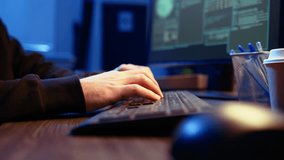 Hacker in secret underground shelter typing on keyboard, writing lines of code on computer, trying to get past security systems with virus. Scammer working on hacking script, camera A close up shot - Powered by Shutterstock - Get 15% off with code: PIKWIZARD15