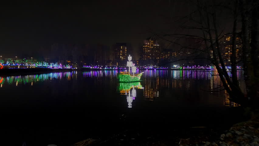 Establishing shot. Lake trail with nice Christmas decoration at night in Vancouver, Canada, North America. Night time on Dec 2023. ProRes 422 HQ