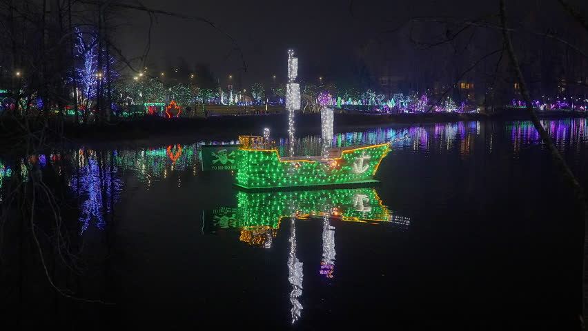 Establishing shot. Lake trail with nice Christmas decoration at night in Vancouver, Canada, North America. Night time on Dec 2023. ProRes 422 HQ