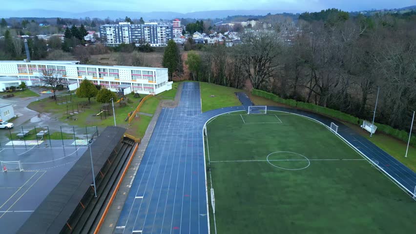 Aerial View of a School Playground with Running Track and Sports Field