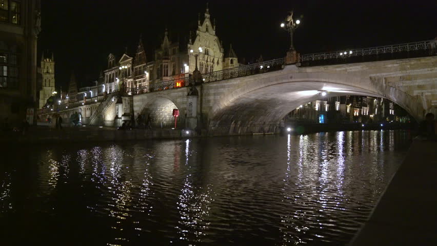 St. Michael’s Bridge at Night Ghent Belgium. Evening in Ghent, Belgium on the banks of the Leie river and the St. Michael’s Bridge amongst the medieval buildings of the old town.

