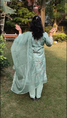 Beautiful woman dressed up as Indian tradition with henna mehndi design on her both hands to celebrate big festival of Karwa Chauth, Karwa Chauth celebrations by Indian woman for her husband