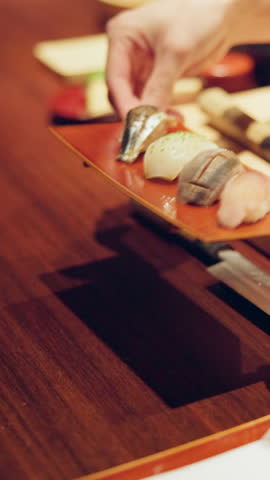 Sushi, plate and hands of chef with catering in restaurant for traditional menu, seafood and fine dining. Cuisine, fish and closeup of person with Japanese meal for kitchen, culture or gourmet dish.