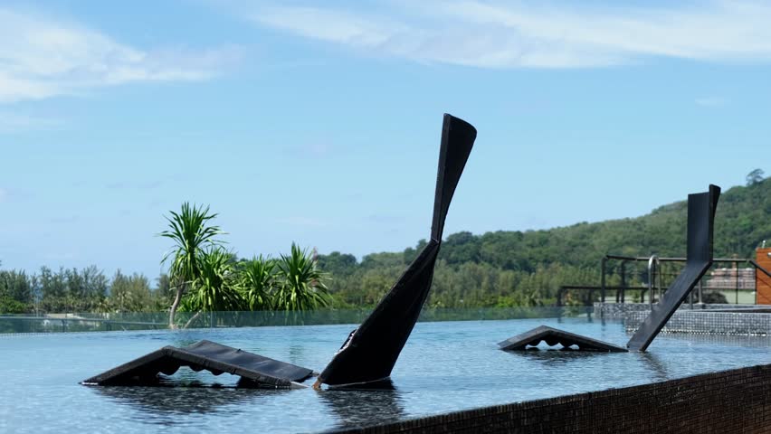 A sunbed by the pool in a tropical setting evokes comfort and relaxation. This scene is perfect for resort and exotic vacation projects, inviting viewers to indulge in leisure.