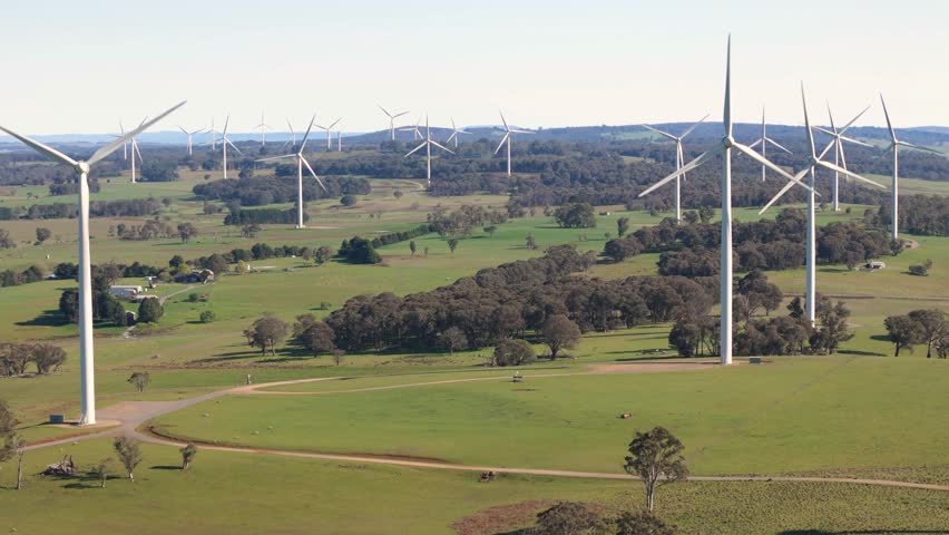 Aerial drone view of an array of large wind turbines at Biala and Gullen Range Wind Farm, Bannister in the Southern Tablelands region of New South Wales, Australia on a sunny day 
